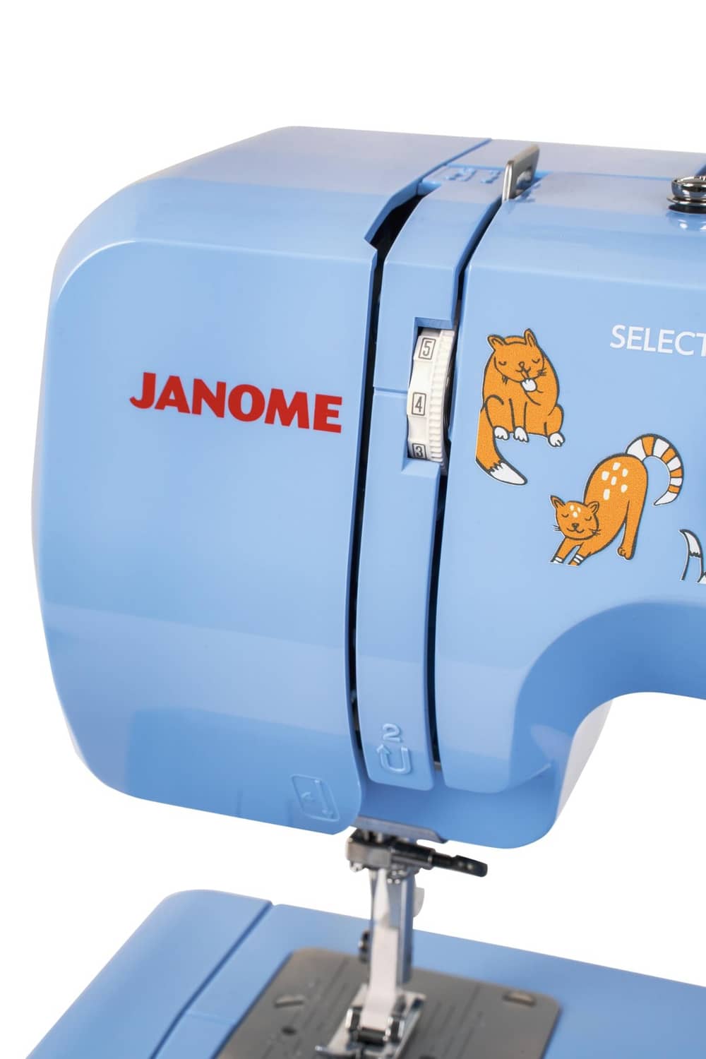 Blue Janome sewing machine close-up of side panel with cat selector and label