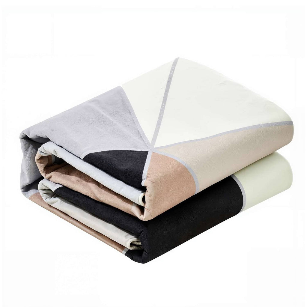Folded geometric area rug bundle with charcoal, beige, and white triangular pattern