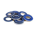 Blue oil drain plug gaskets, stacked with round center holes