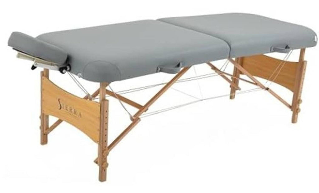 Gray portable massage table with padded headrest and wooden folding frame