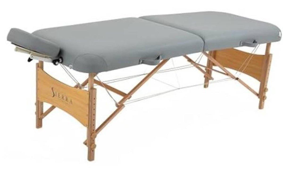 Gray portable massage table with padded headrest and wooden folding frame