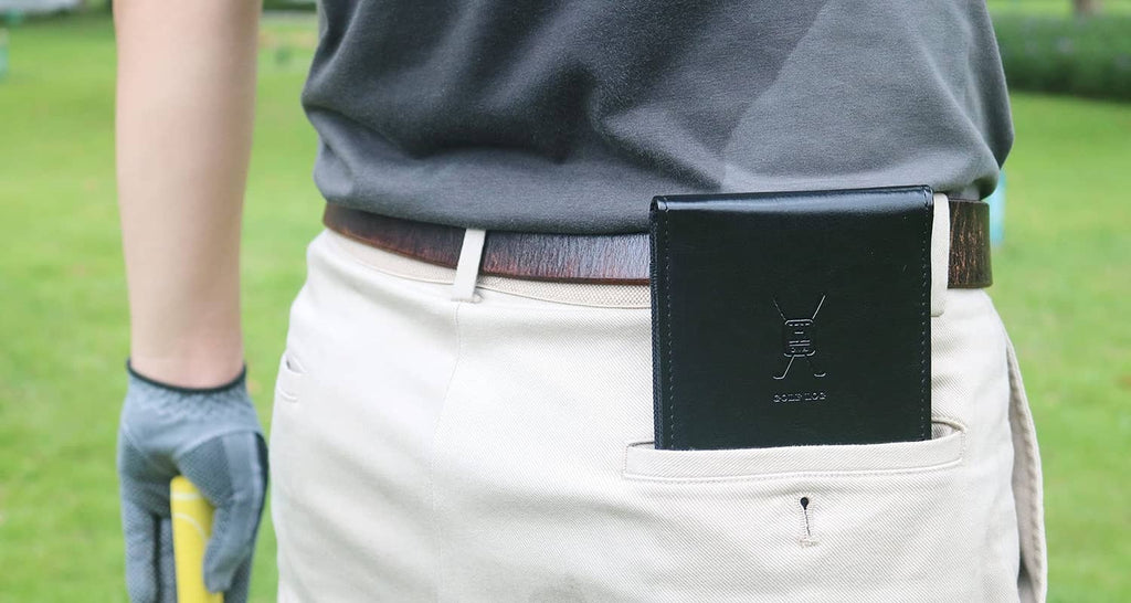 Black leather scorecard holder clipped on golfer’s belt, rectangular front logo