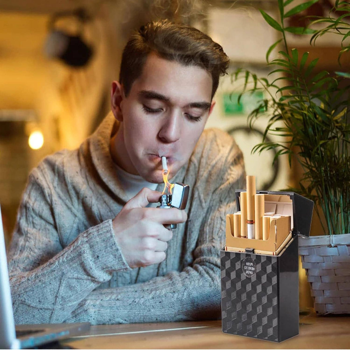 King-size cigarette case in black with textured pattern, push-to-open and in use