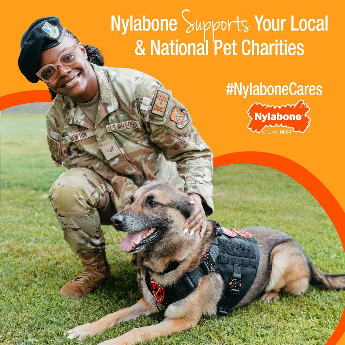 Dog and handler with Nylabone pet charity message and chew bone