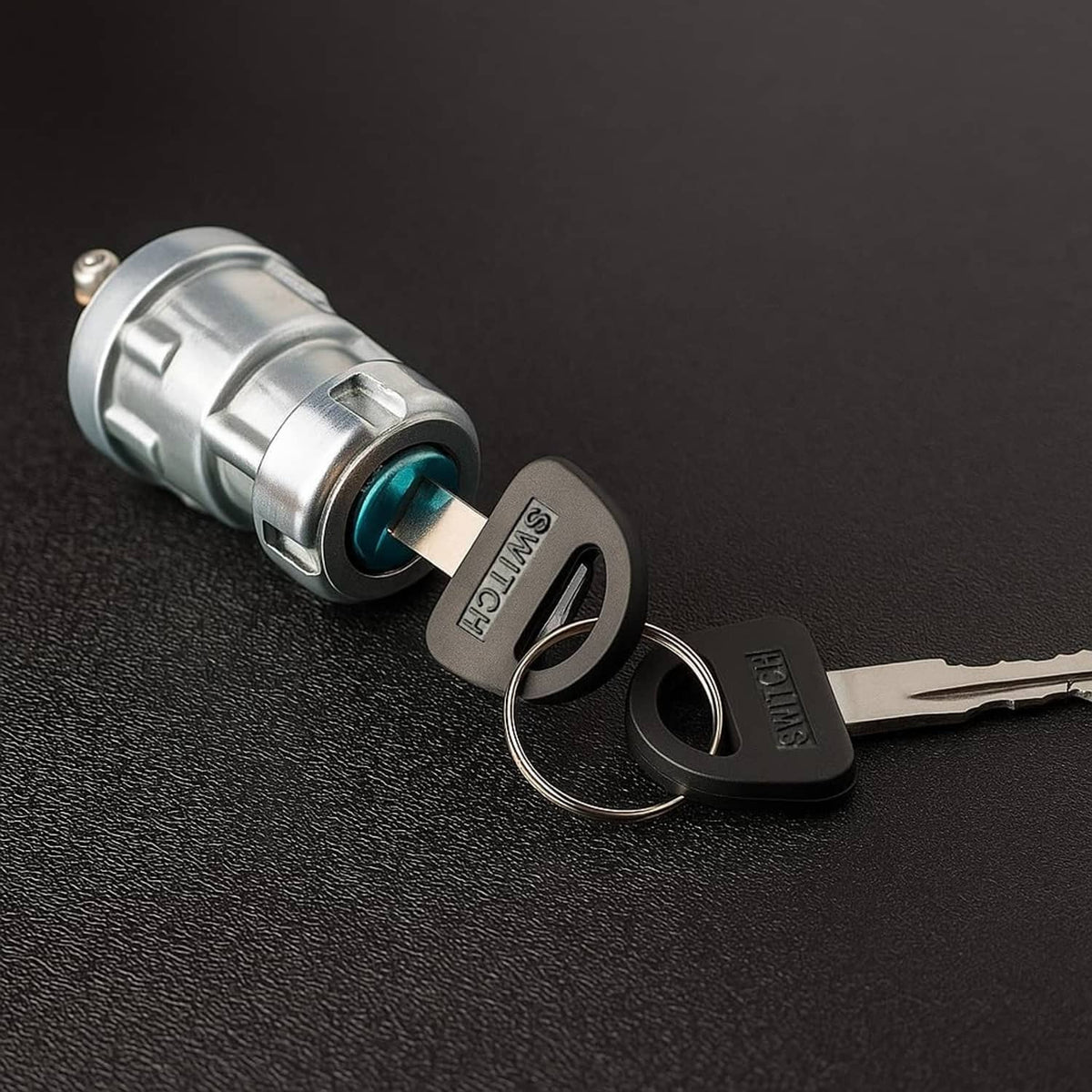 Ignition key switch with two keys on silver metal cylinder, blue insert