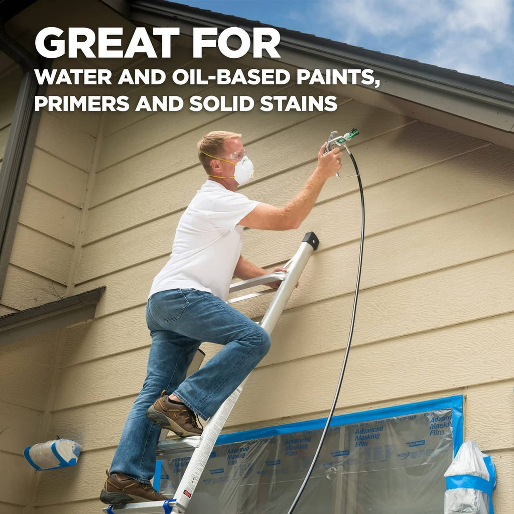 Spray gun with green 619 tip applying paint on a house exterior
