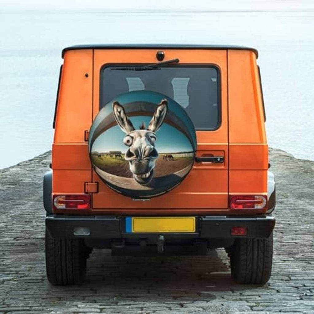 Spare tire cover on an orange vehicle rear with circular donkey face graphic