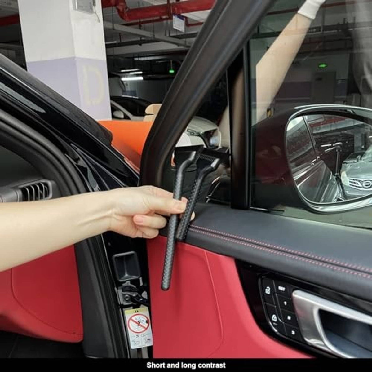 Hand holding squeegee tool to apply or smooth window tint film