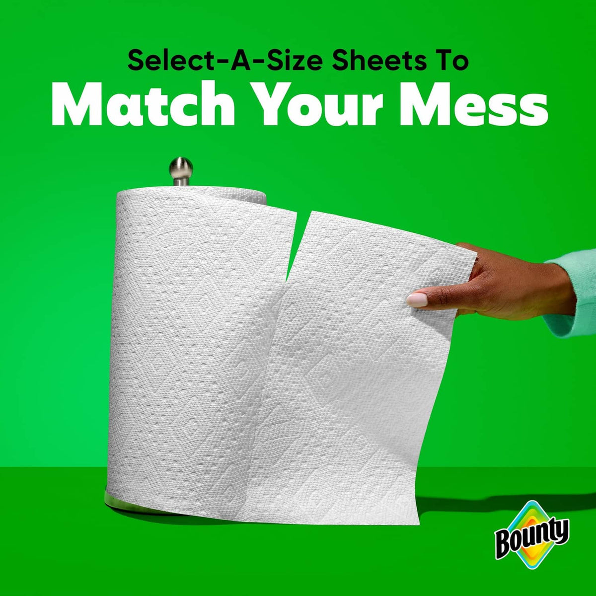 Two rolls of white paper towels, showing loose sheets held by a hand