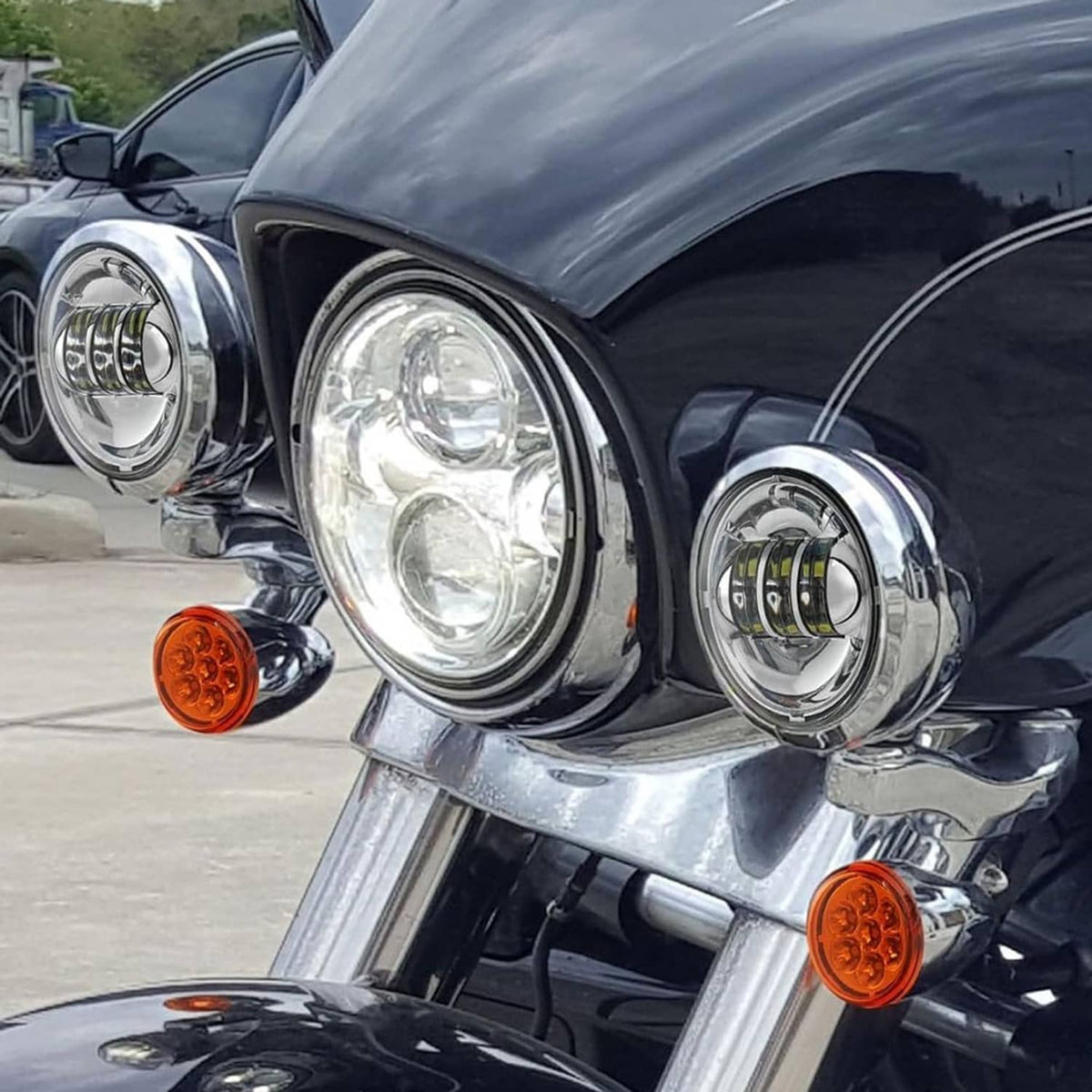 Chrome auxiliary LED lamps with amber turn markers on a black motorcycle fairing