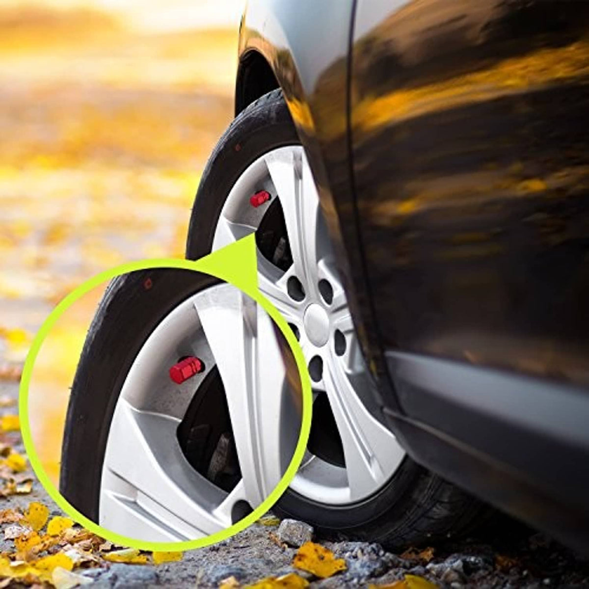 Red tire valve cap installed on a car wheel, highlighted near the tire valve