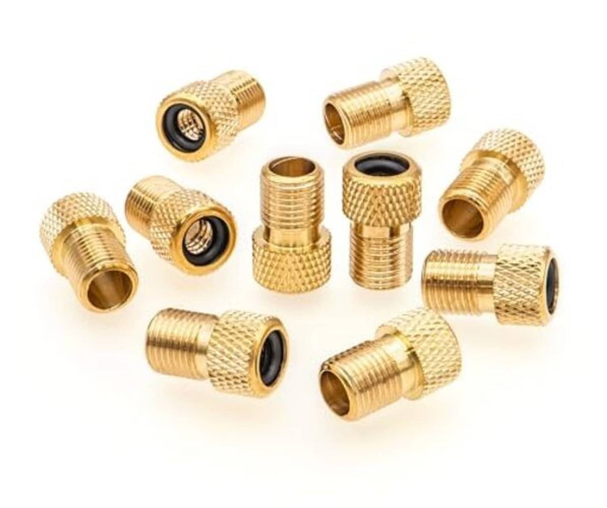 Assorted brass Presta valve adapters with black rubber inserts, multiple pieces