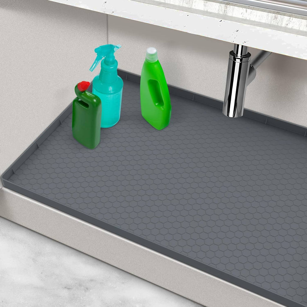 Gray under-sink silicone mat with hex-pattern surface and raised edges