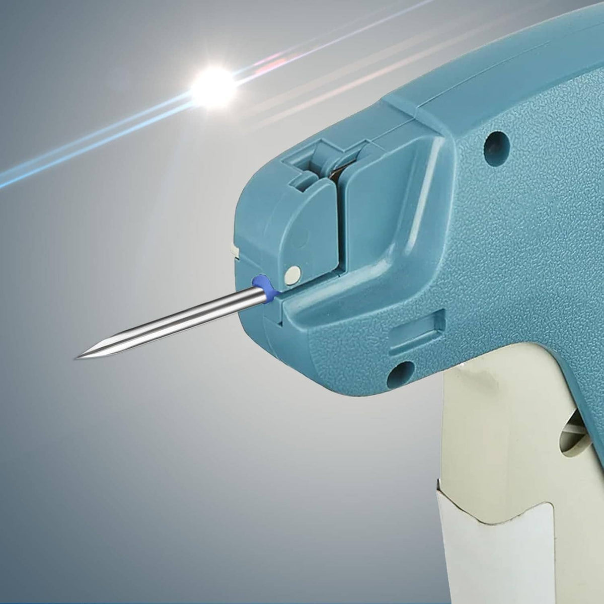 Close-up of tagging gun nozzle with steel needle tip in blue housing