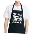 Black BBQ apron with humorous 'MY Wife is HOTTER than my GRILL' print and straps
