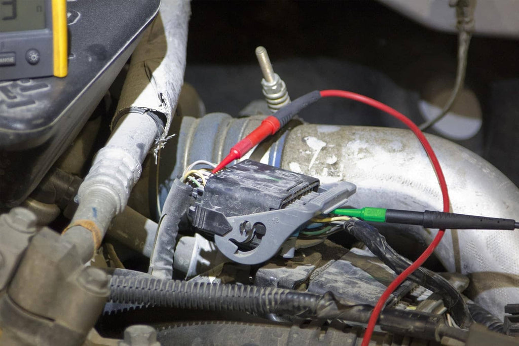 Back probe pins and alligator clips connected to automotive wiring and terminals