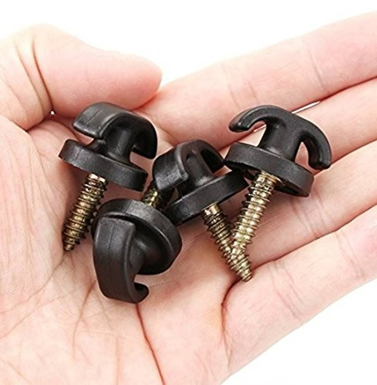 Four black cargo net replacement hooks with gold screws, shown in hand