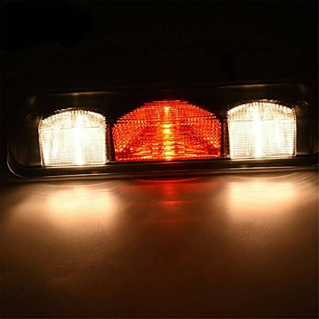 Illuminated rear center brake light lamp with red lens and clear side sections