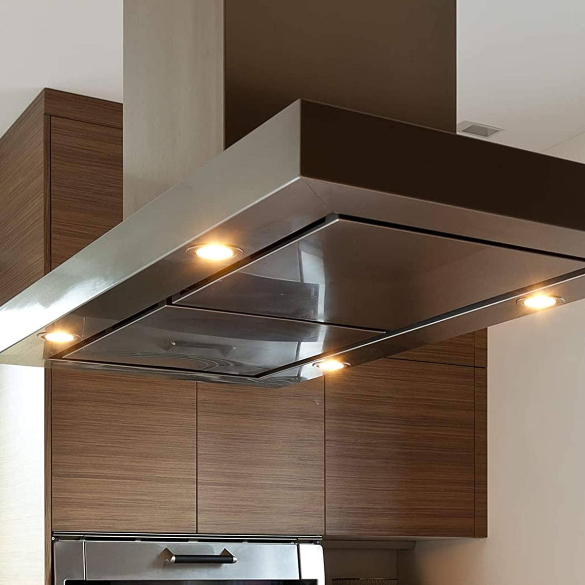 Halogen bulbs glowing inside kitchen range hood under-cabinet fixture