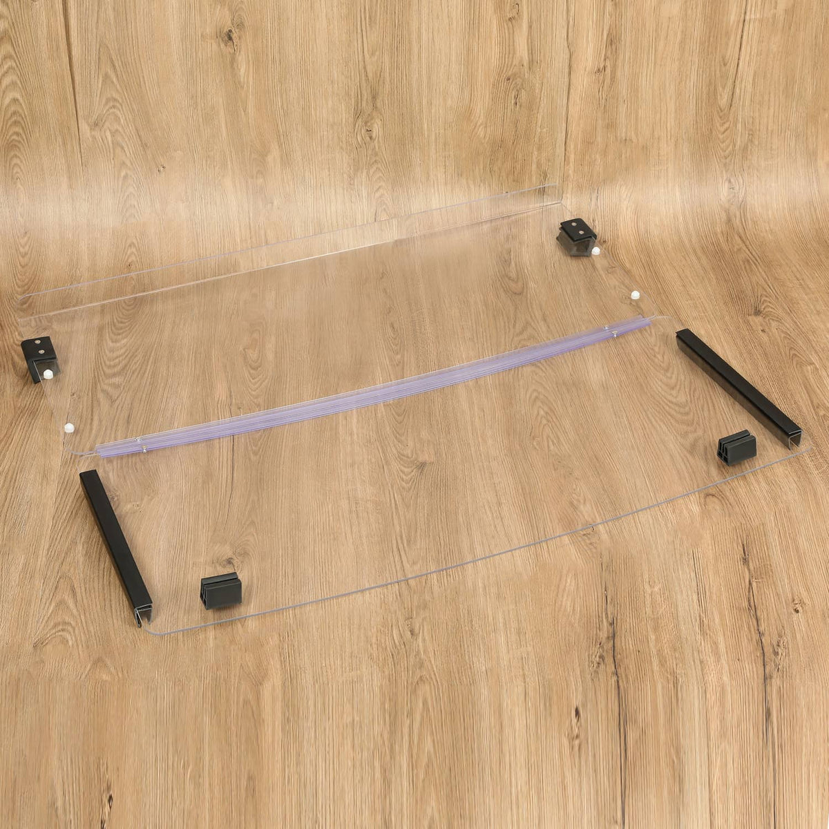 Clear windshield panel and support bar with black brackets and mounting clips on wood