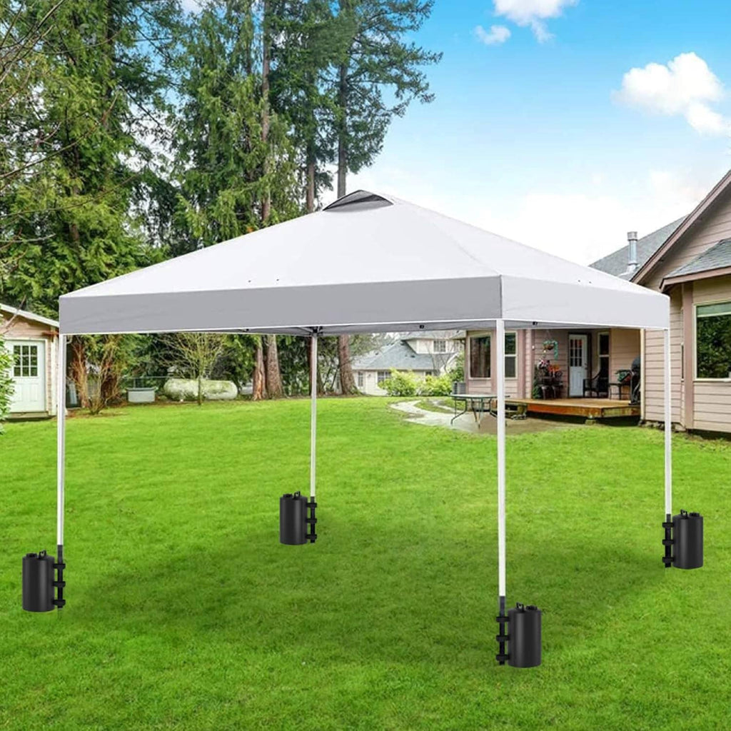 Black water weight bag attached to canopy leg with side straps on outdoor lawn