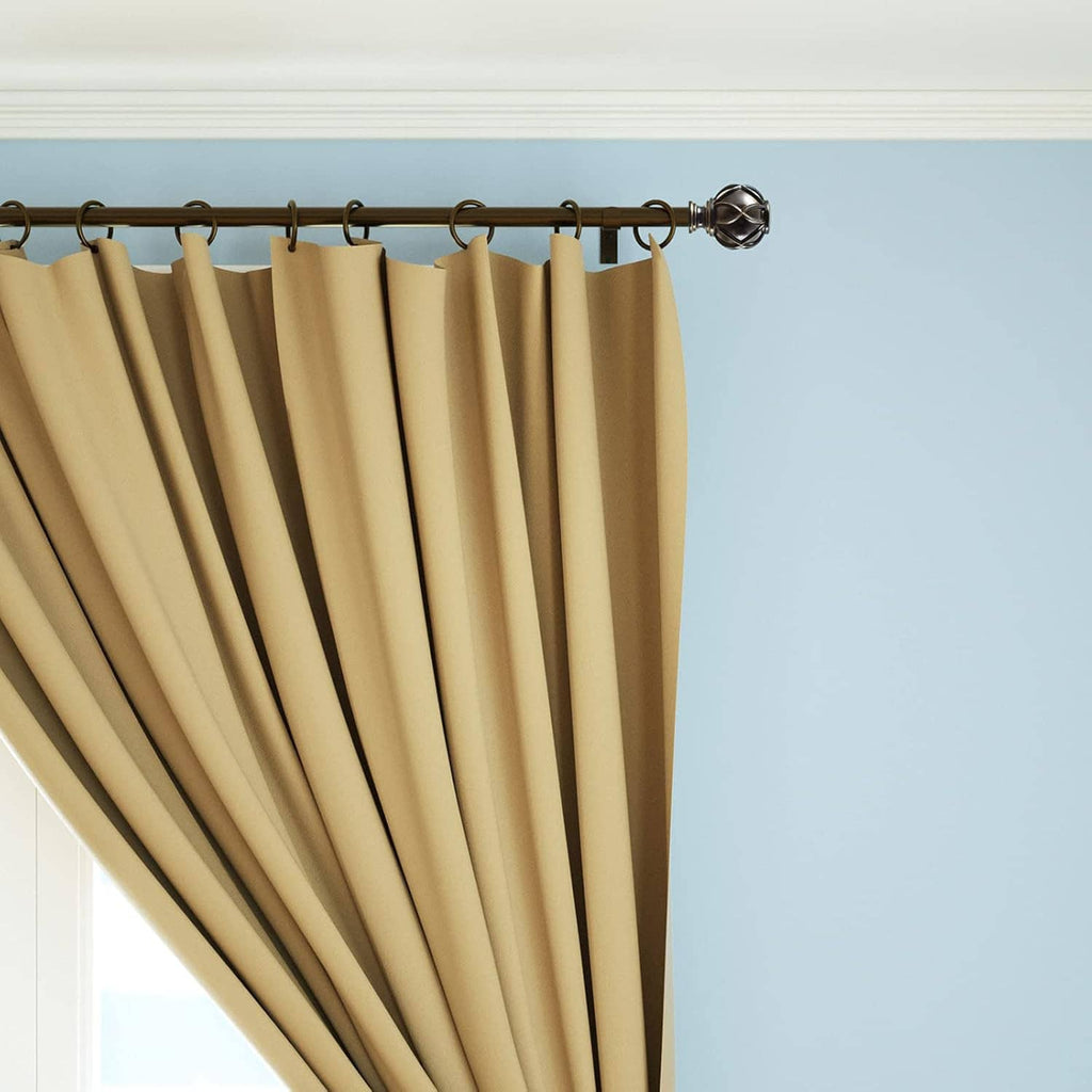 Gold-toned curtain rod finials with sculpted diamond pattern along the rod