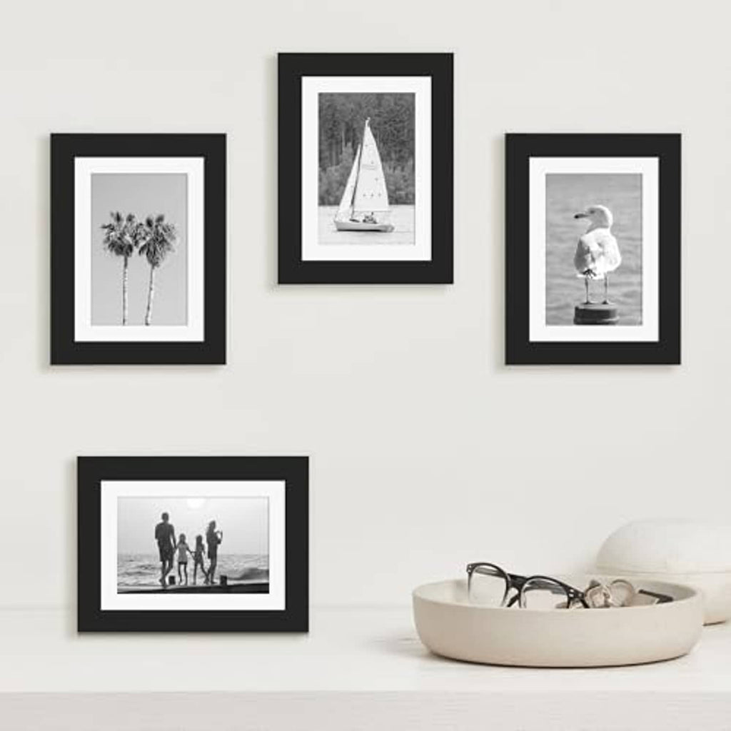 Black wood picture frame set with white mats featuring multiple small photo prints