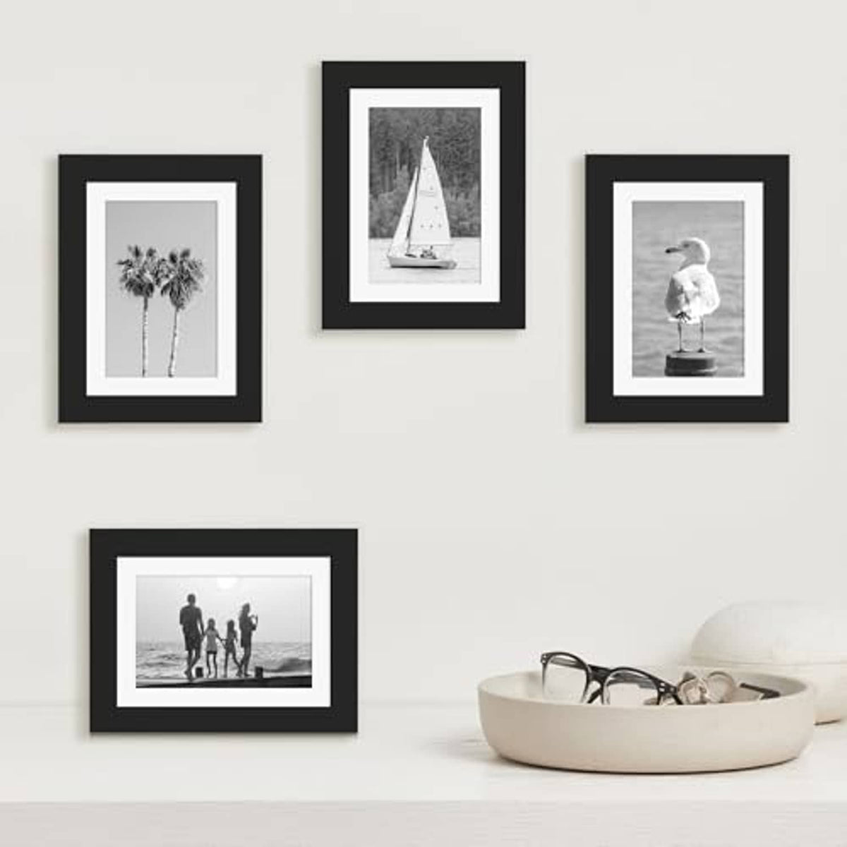 Black wood picture frame set with white mats featuring multiple small photo prints