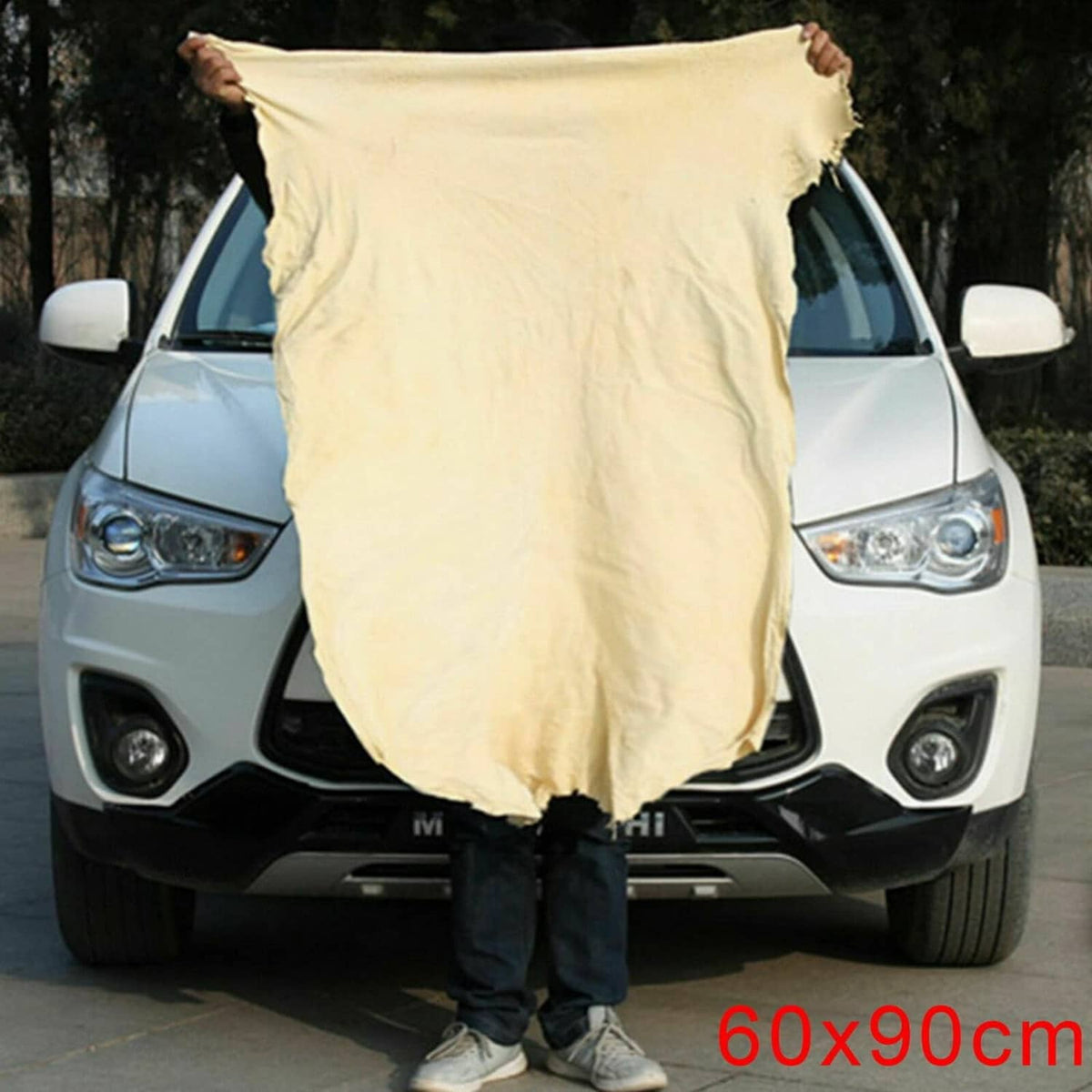 Off-white chamois leather cleaning cloth held over a car front, 60x90 cm
