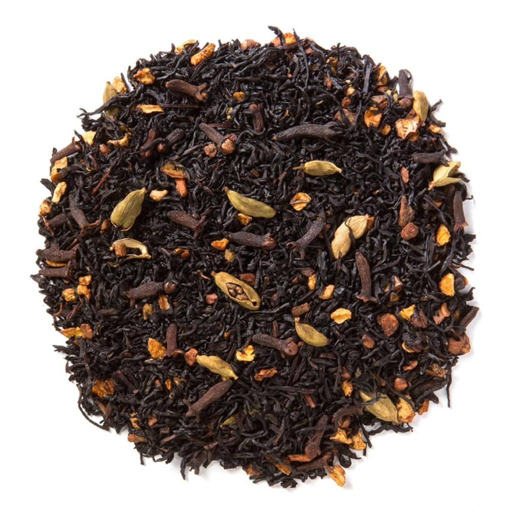 Loose-leaf black chai tea with visible spices and orange peel pieces in a heap