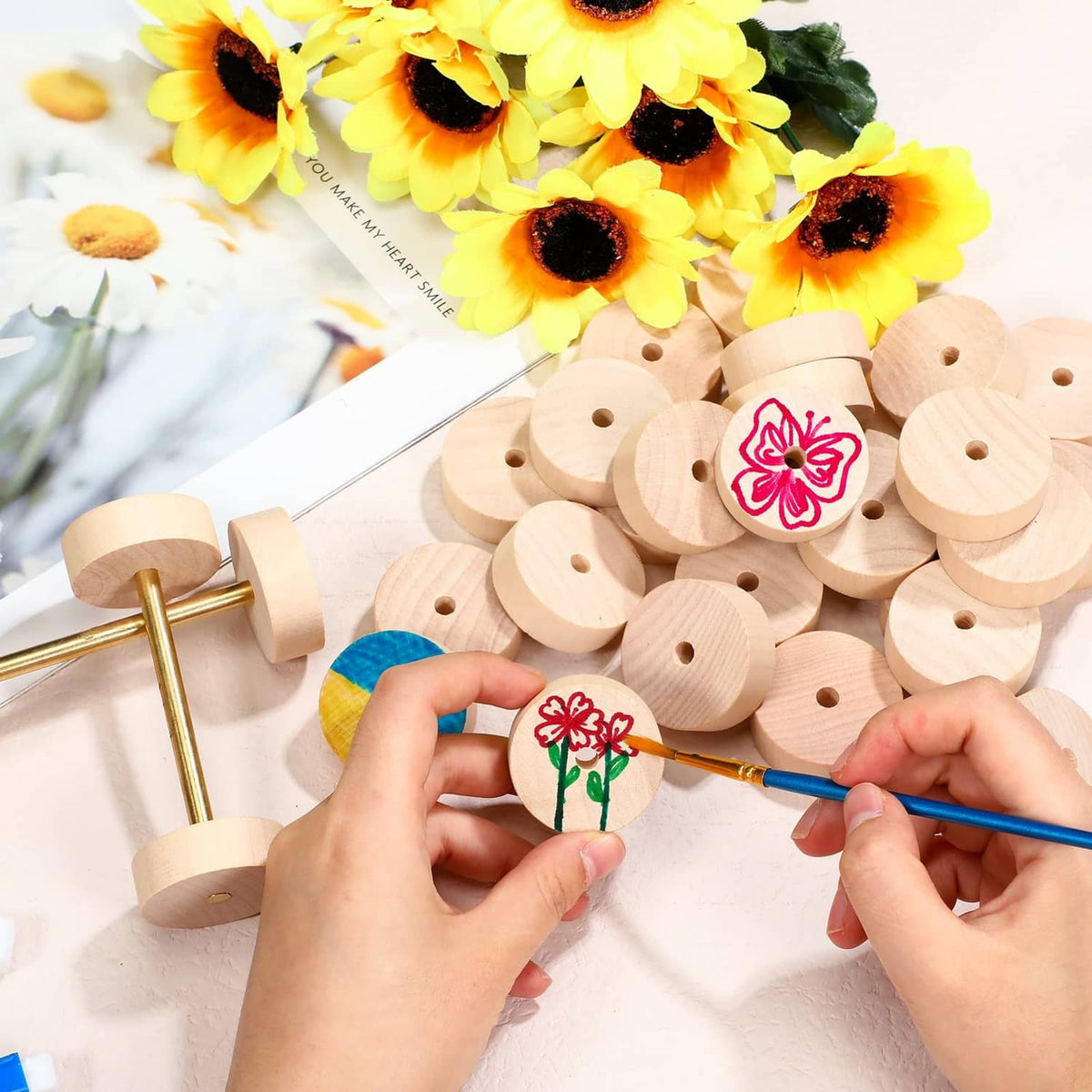 Round light wood craft wheels with center holes on a sewing-stitch style assembly board