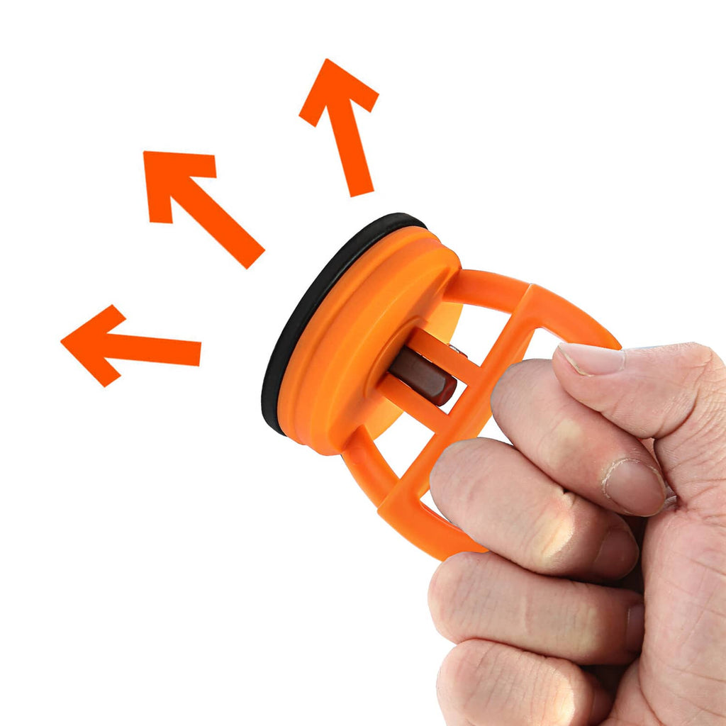 Hand holding an orange suction cup dent puller tool with black suction pad