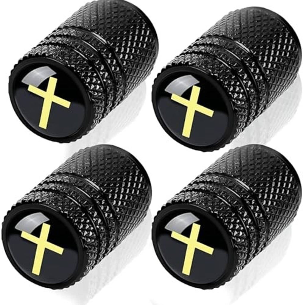 Four black textured tire valve stem caps with yellow cross emblem