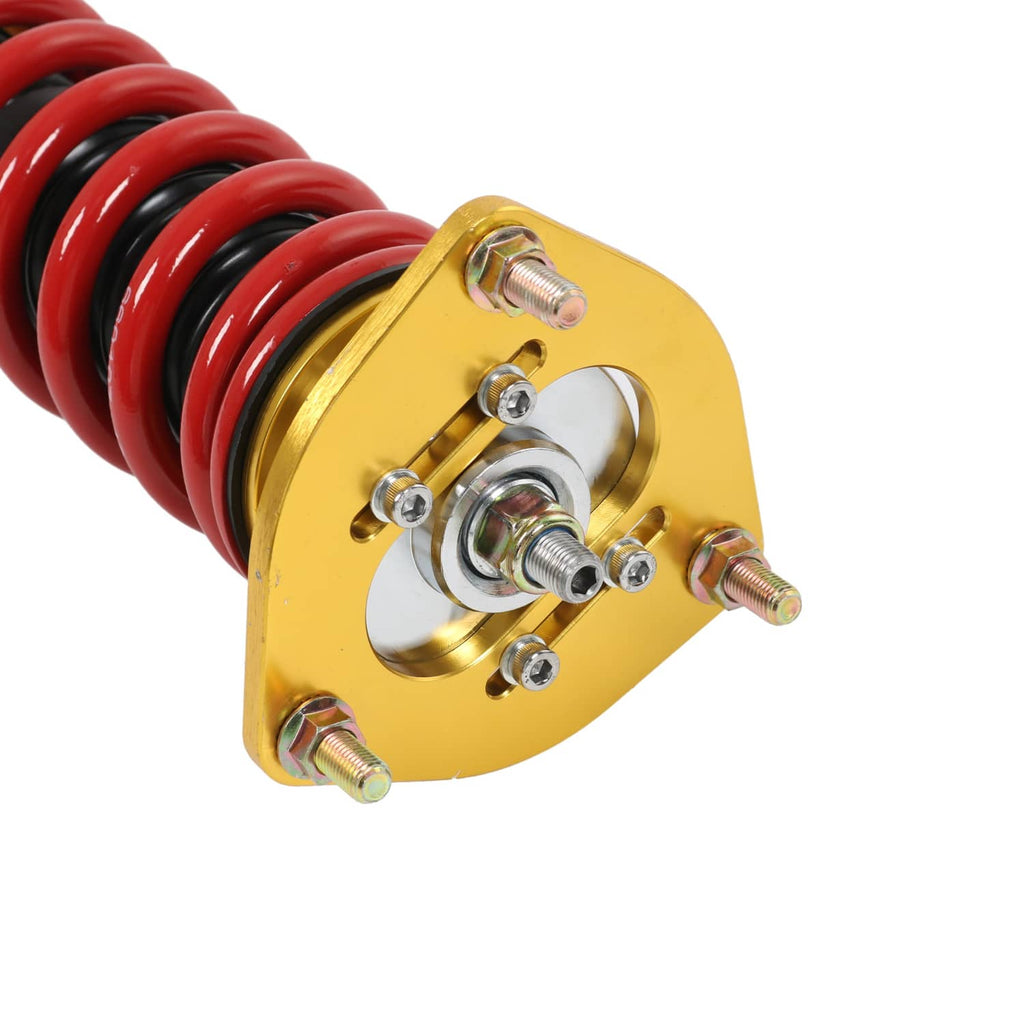 Red coil spring with gold top mount plate and hardware on suspension strut