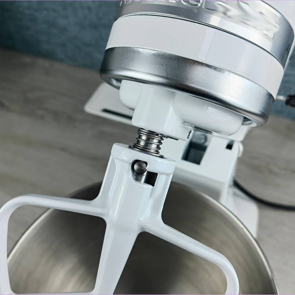 Close-up of chrome threaded stem and spring hardware on mixer head
