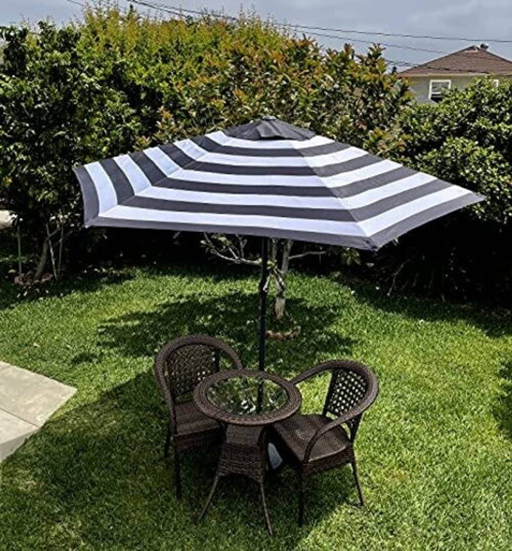 Black-and-white striped patio umbrella replacement canopy, fully opened over a base