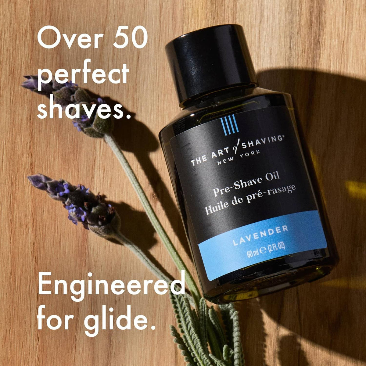 Lavender pre-shave oil bottle with black cap and lavender sprigs, The Art of Shaving.
