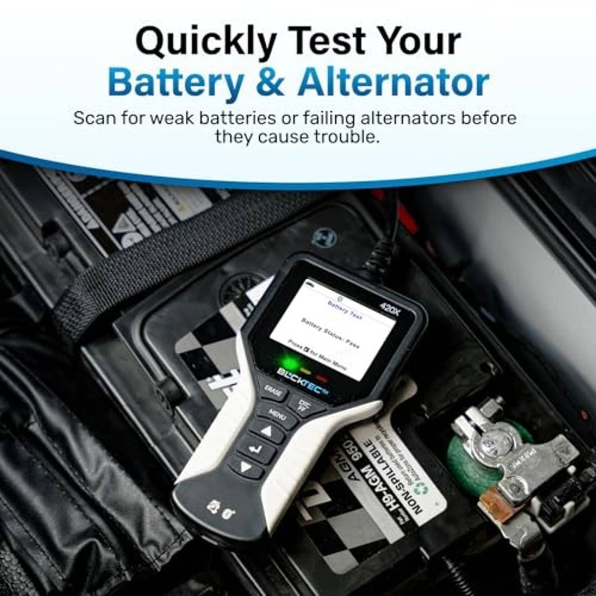 OBD2 scanner in car engine bay with screen lit and buttons visible