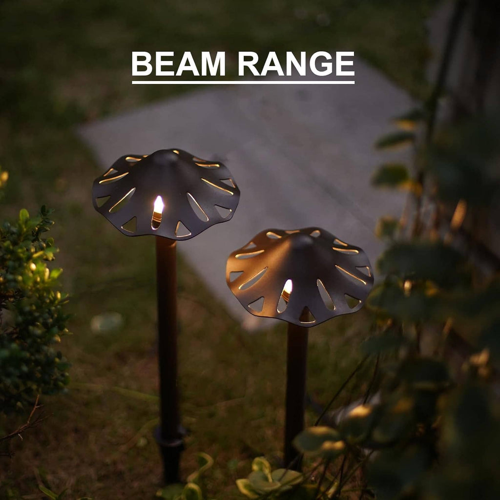 Two glowing low-voltage LED pathway lights with decorative round perforated caps