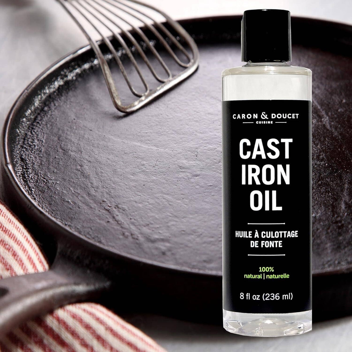 Caron & Doucet Cast Iron Oil bottle with black cap, 8 fl oz (236 ml) front label.