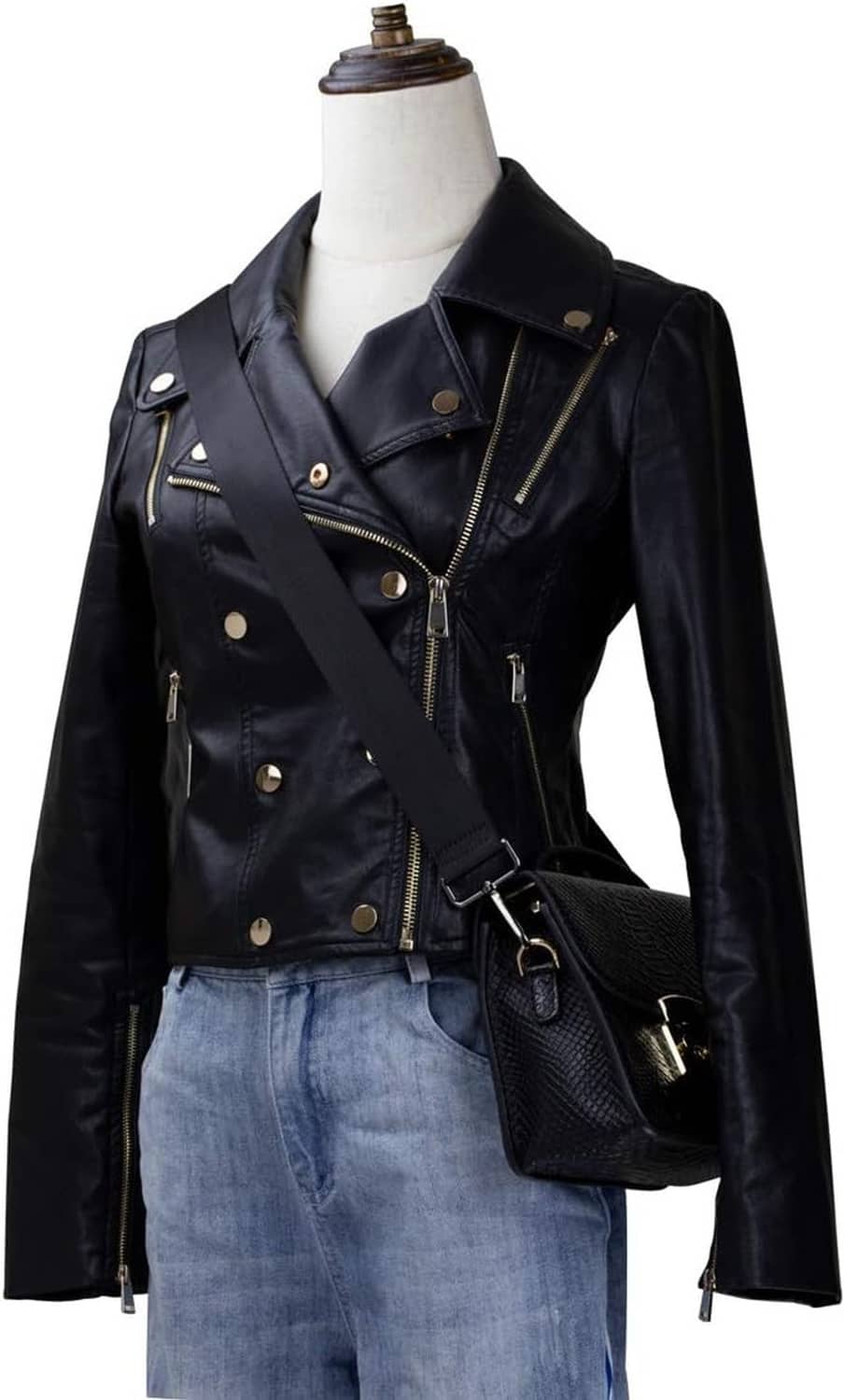 Adjustable black crossbody strap on a bag, worn across the chest with metal clips