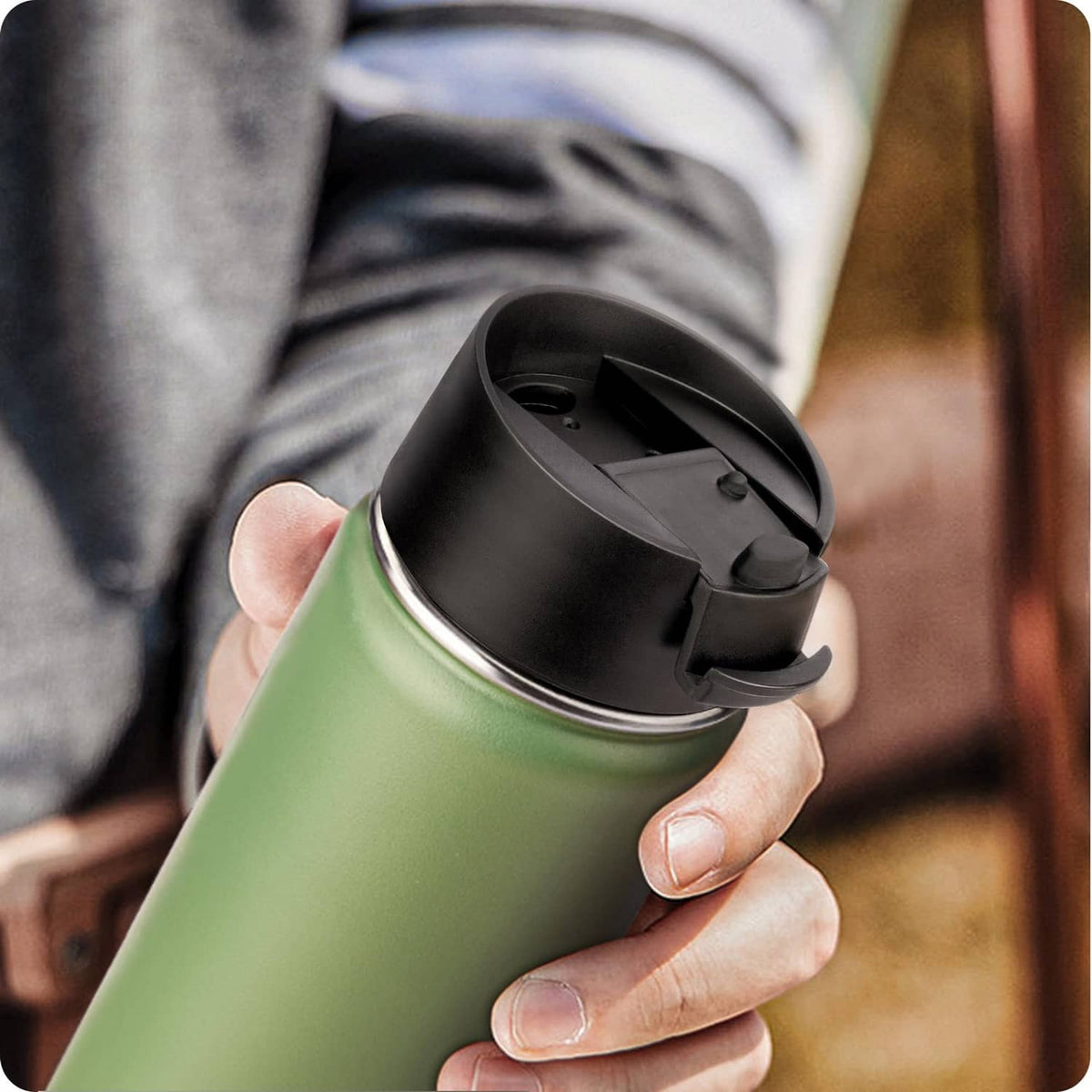 Black flip-top lid on bottle with closed hinged cover and small latch