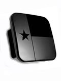 Black metal hitch receiver cover plug with Texas star emblem and hinged design.