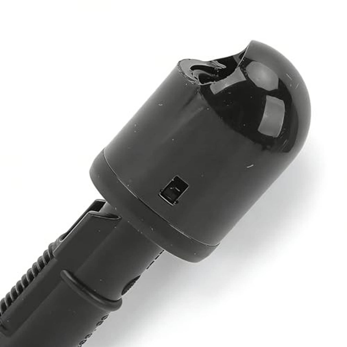 Black headlight washer nozzle spray tip and ribbed hose connector, close-up side view.