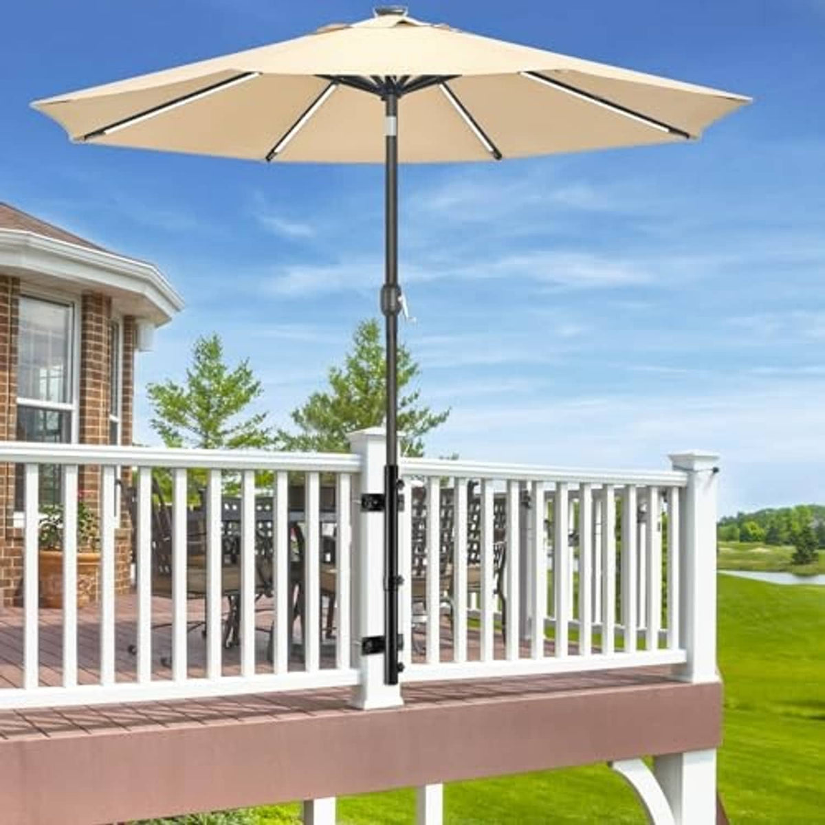 Black adjustable umbrella holder mounted on balcony railing post with clamp arms