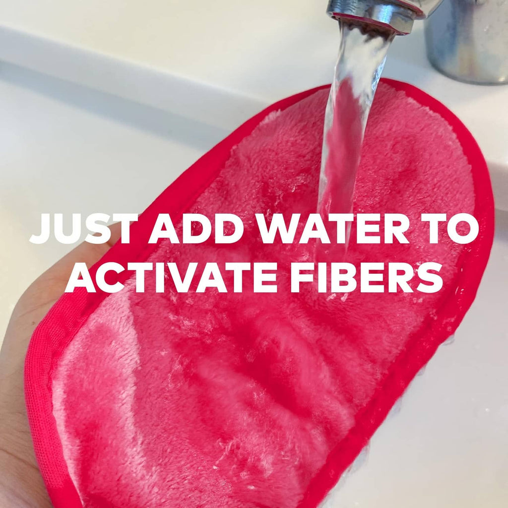 Pink MakeUp Eraser cloth getting water to activate cleaning fibers.