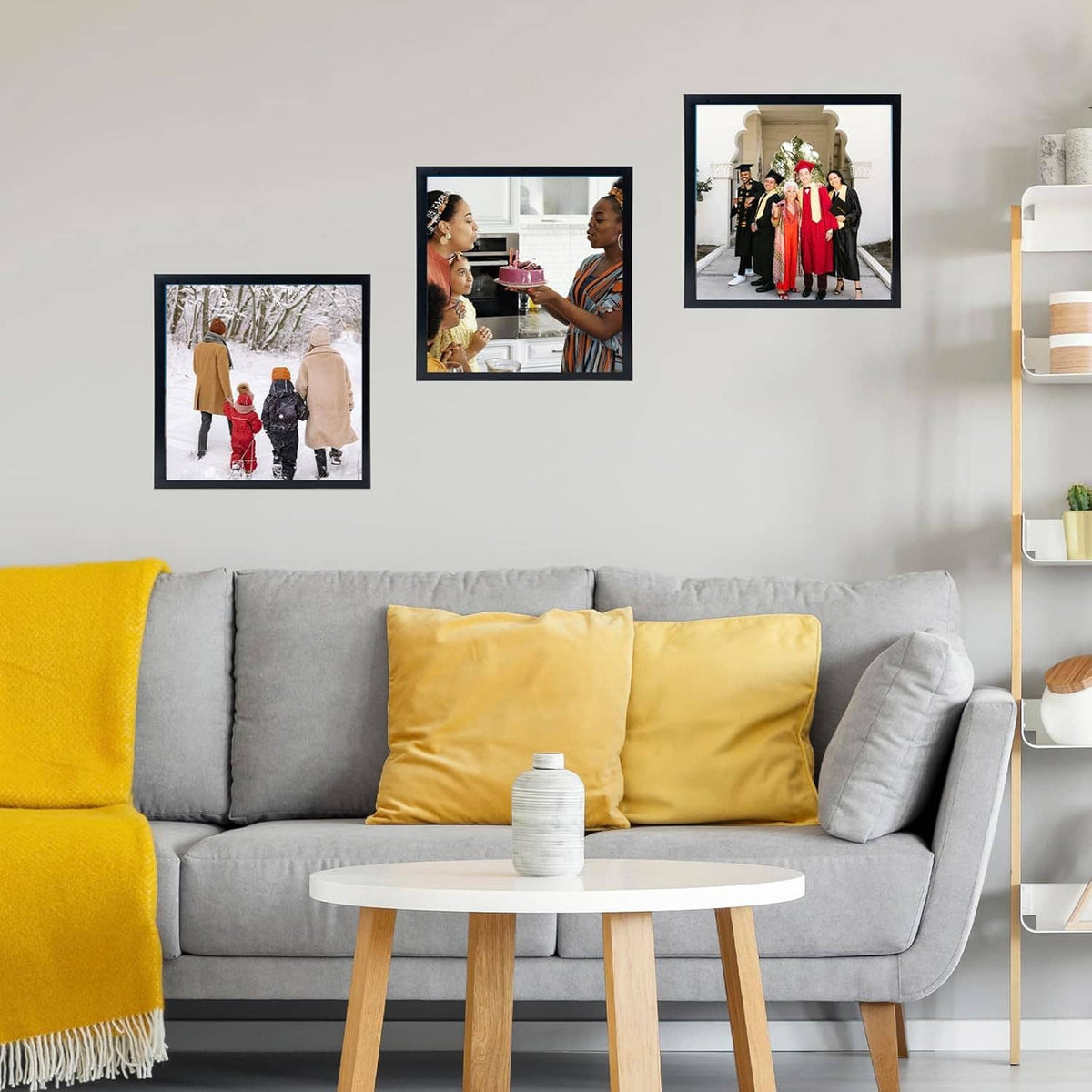 Black photo frame on wall with people photos, mounted in a living room