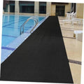 Pool deck floor mat runner with textured, non-slip diamond grid surface along pool edge