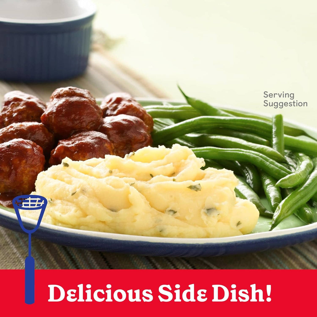 Mashed potatoes served with green beans and meatballs