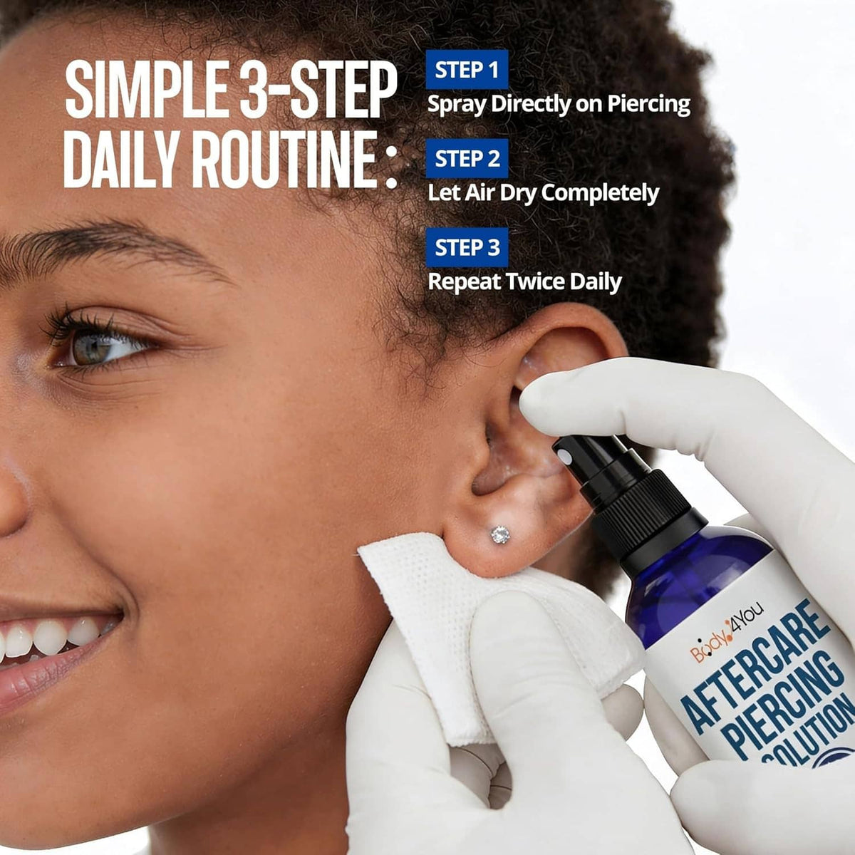 Piercing aftercare saline spray applied by gloved hand near ear piercing